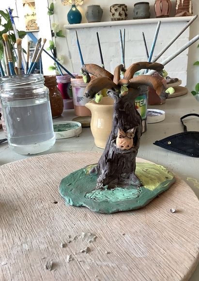 hand modeled clay tree with a green base