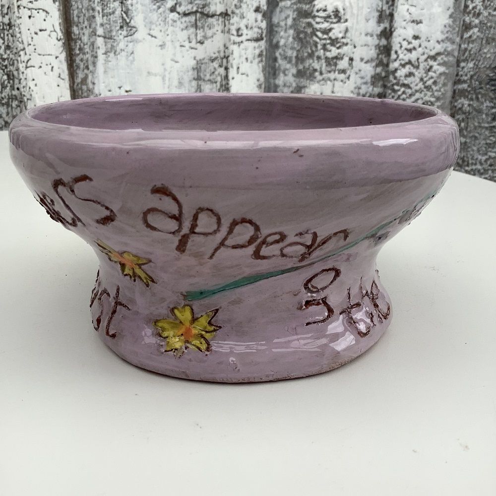 purple pot with inscription and flowers quoting the bible 