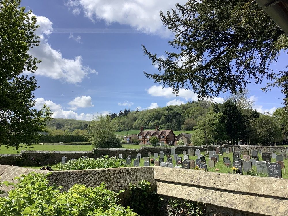 landscape view of eastnor pottery and estate office with church yard in the foreground