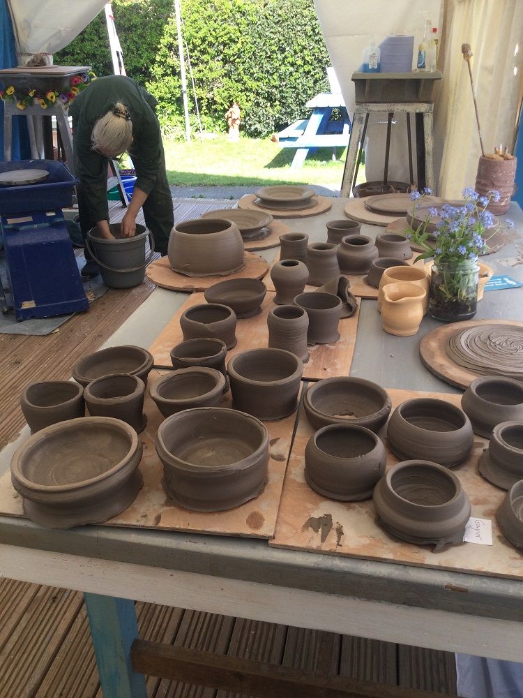 cleaning the wheels and tidying up after day potter's wheel course