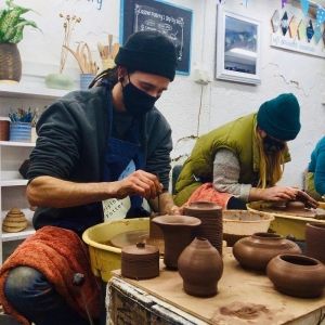 course participants at eastnor pottery amking pots on the potter's wheel