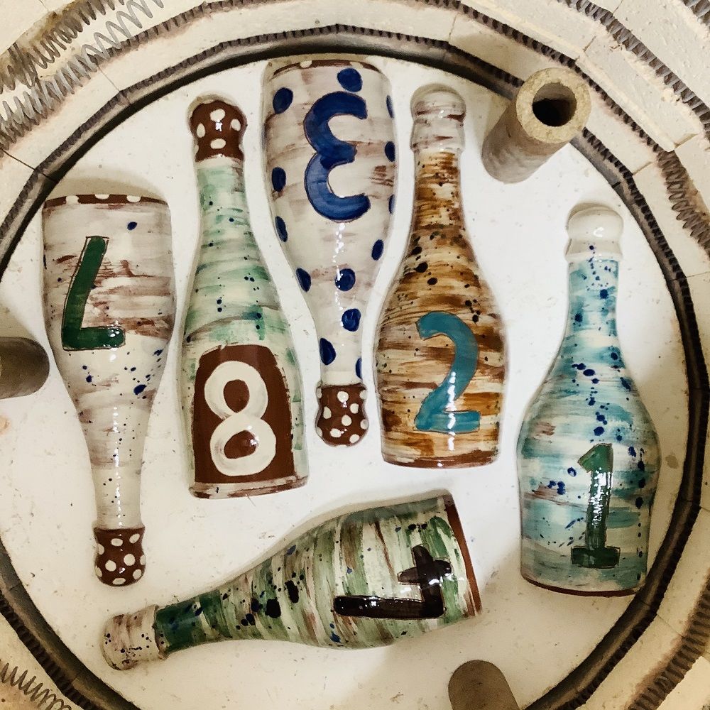 terracotta bottles post firing painted and glazed inside the kiln