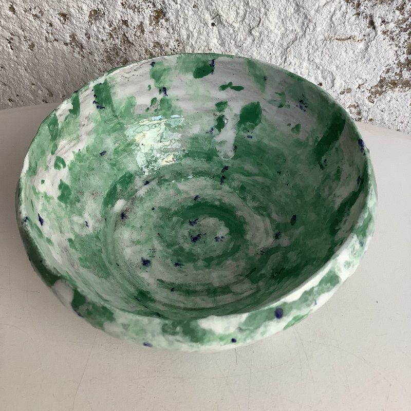 green and white and made pot thrown on the potter's wheel