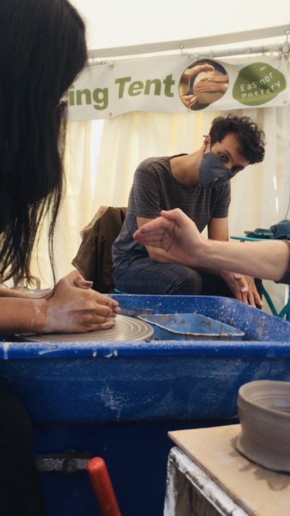 masked pottery classes taking place in the potting tent at eastnor pottery herefordshire