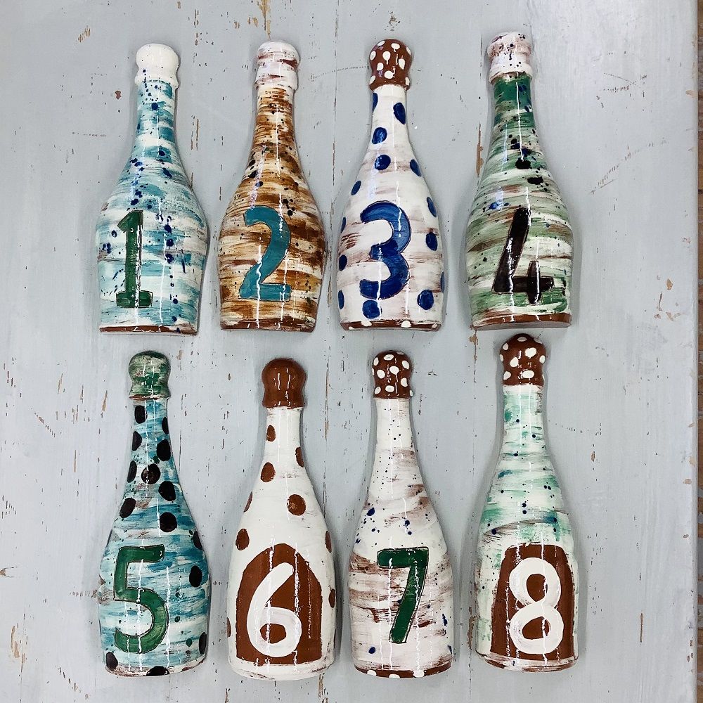 green white and blue decorated bottles from numbers 1 to 8