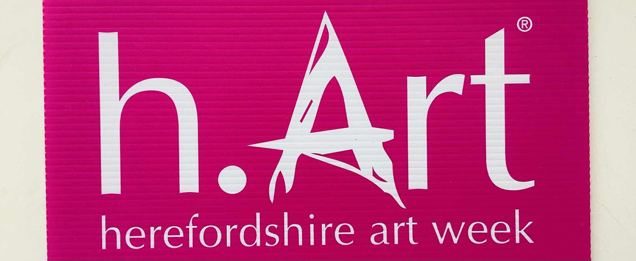Bright pink background with white letter logo saying h.Art Herefordshire Art Week