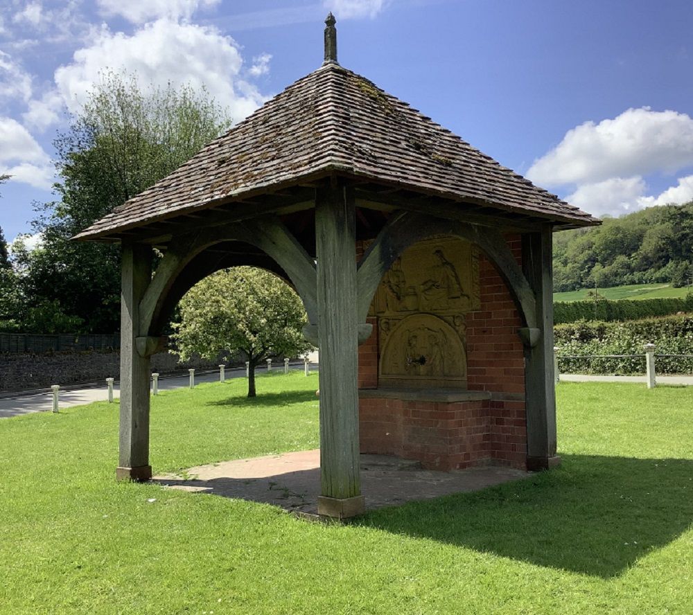 eastnor village triangle wooden with brick roof