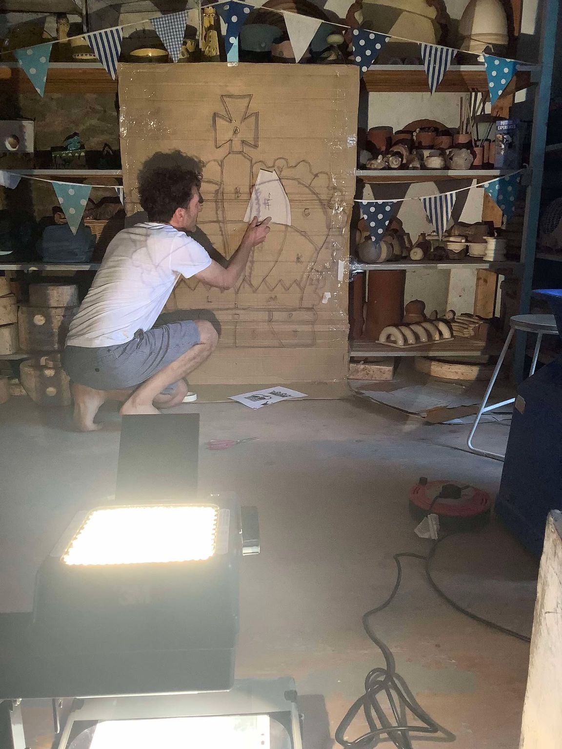 ceramic artist jon williams drawing a large crown 1m high in preparation for a school project tile panel to commemorate queen elizabeths platinum jubilee