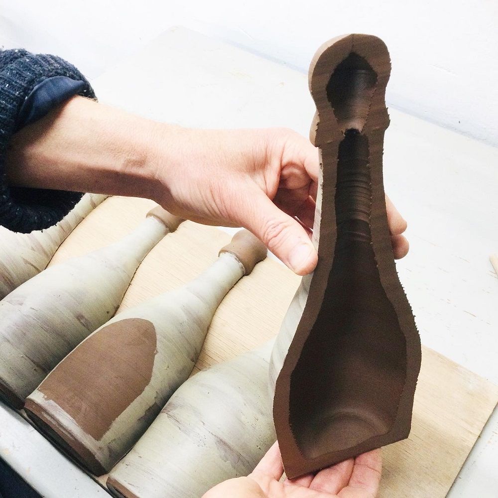 terracotta bottle cut in half being held