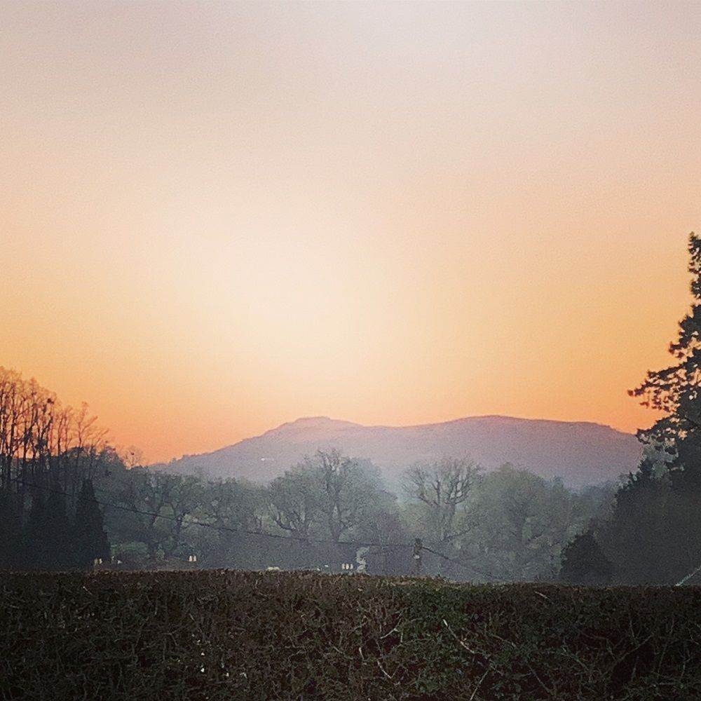 sunset over the malvern hills taken from the pottery car park at eastnor pottery