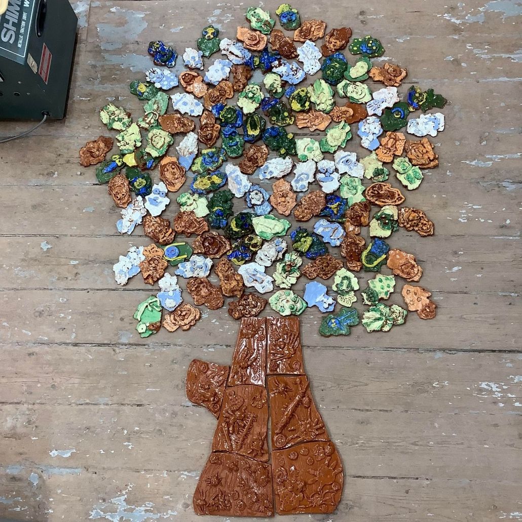 pottery tiles made by school children arranged in the shape of an oak tree