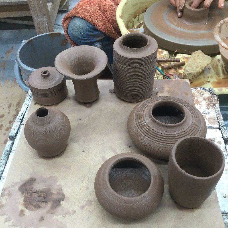 a board of freshly thrown pots made by a potter's wheel course participant at eastnor pottery and the flying potter