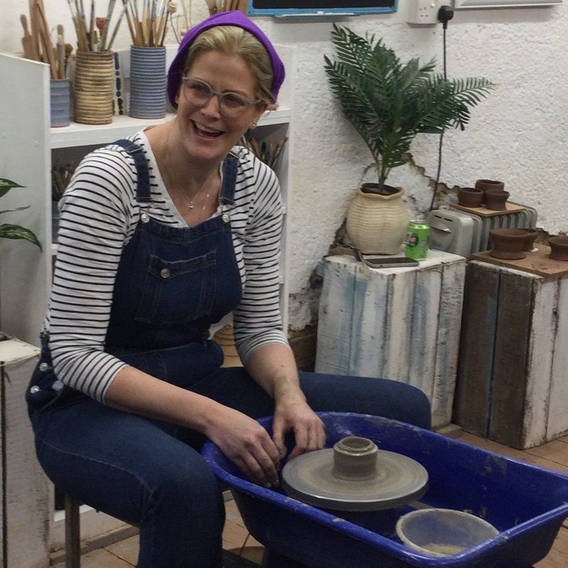 hen party participant making a pot on the potter's wheel at eastnor pottery