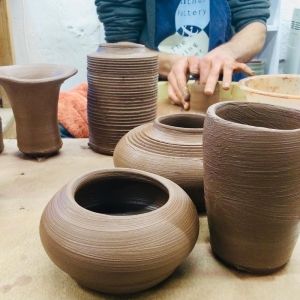  a board of wheel thrown pot made by a course participant at eastnor pottery