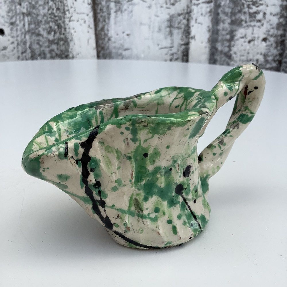 small jug painted white with green and blue splatters