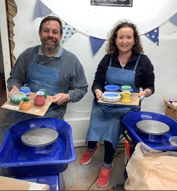 couple displaying their finished pottery they have just made on a weekend course at eastnor pottery herefordshire