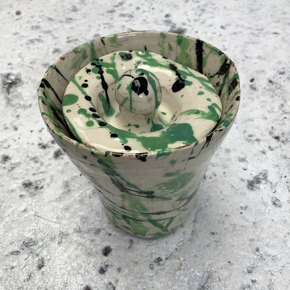 pot with a lid painted white with green and blue splatters