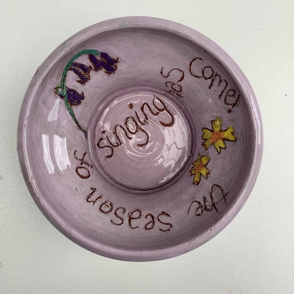 purple pot from birds eye eye with inscription and flowers quoting the bible