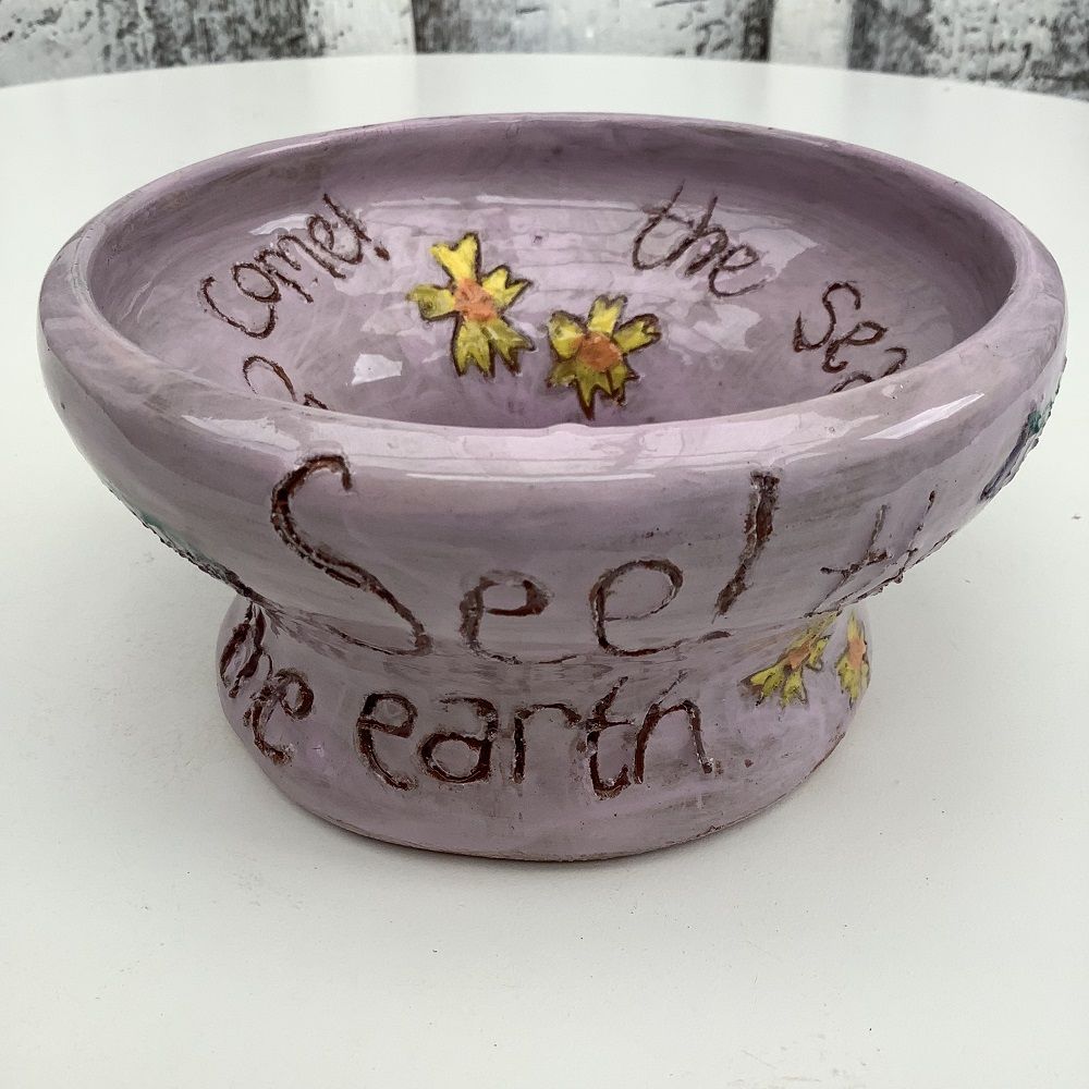 purple pot with inscription and flowers quoting the bible