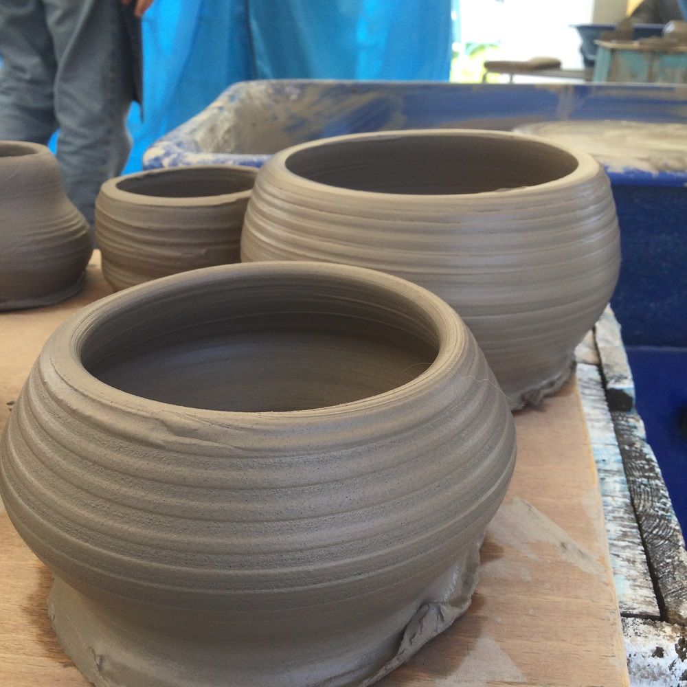 freshly made pots made on the potter's wheel by course participants at eastnor pottery herefordshire