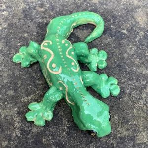 green pottery lizard made on a family workshop at eastnor pottery over easter