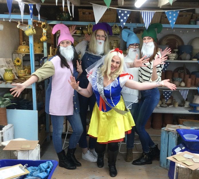 hen party group dressed as snow white and her dwarfs on a pottery making hen party at eastnor pottery