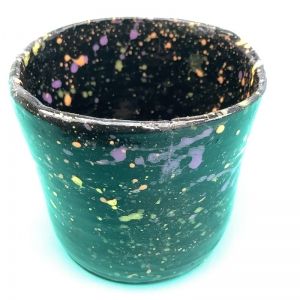 black hand made pot with bright splats of vivid pinks and yellows