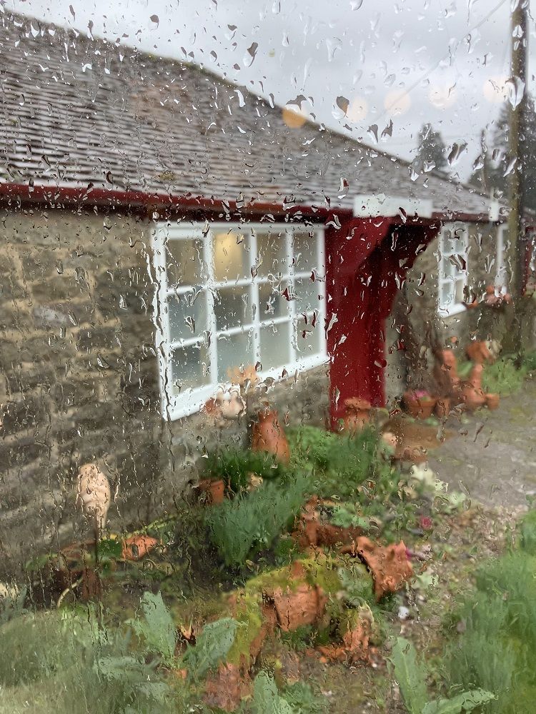 eastnor pottery viewed through a rain splattered window