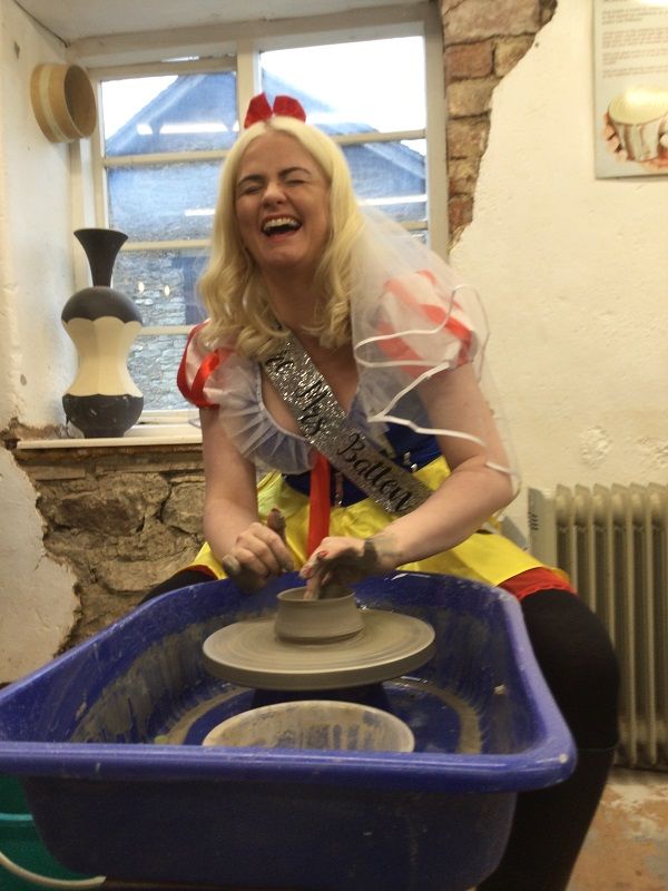 snow white having lots of fun making a pot on the potter's wheel at eastnor pottery