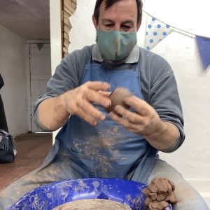 weekend pottery course participant handles the clay